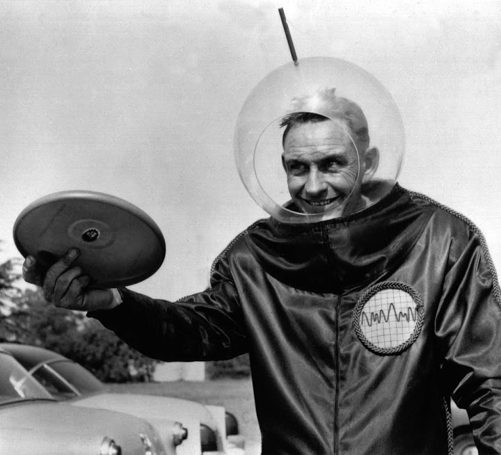 Richard Knerr, founder of Wham-O, wears a space suit and prepares to throw a frisbee