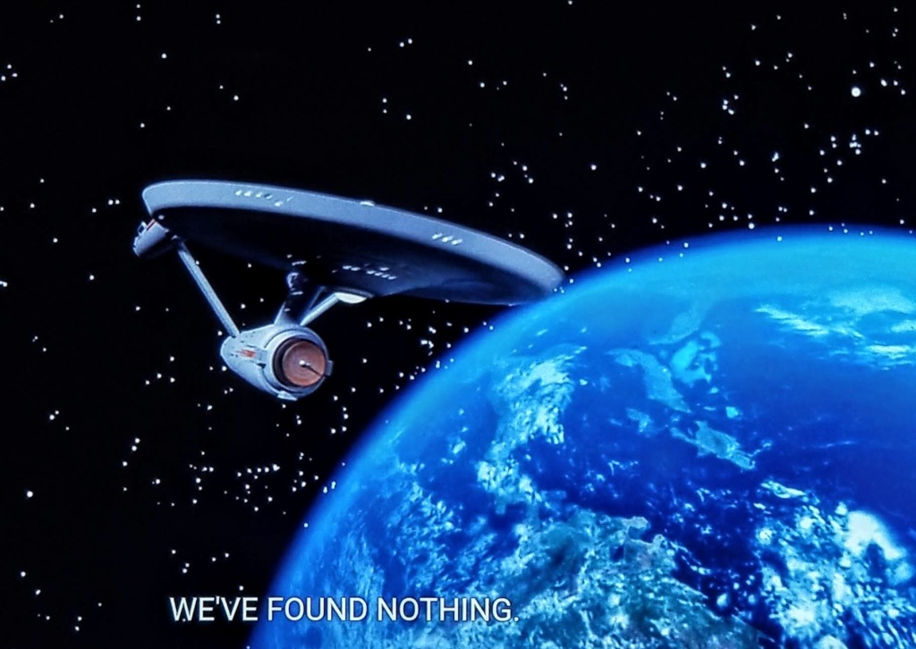 The Star Trek Original Series Enterprise circles a planet, boldly. The closed caption reads "We've found nothing."