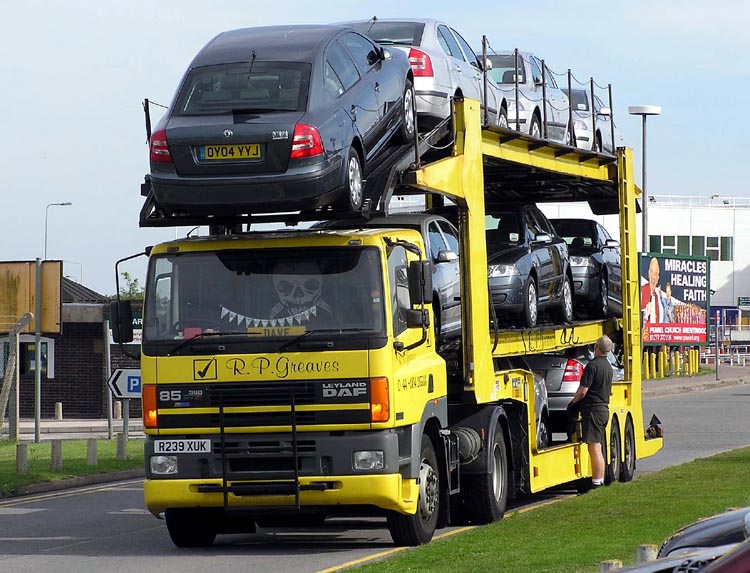 A tractor unit with a car carrier trailer carrying 2004 Skoda Octavias.