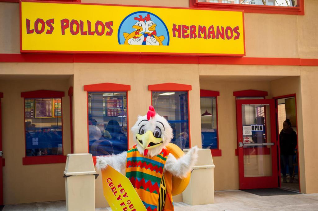 Person busking in a chicken suit in front of Los Pollos Hermanos, a restaurant from Better Call Saul and Breaking Bad
